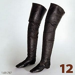 Pair of tall, black leather boots worn by Buffalo Bill during his performances, showcasing intricate craftsmanship and historical significance.