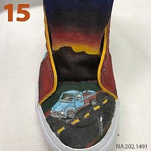 Custom painted sneaker by artists from St. Labre Indian School featuring a vibrant sunset and a scenic road with vehicles, entered in Vans Custom Culture 2016.