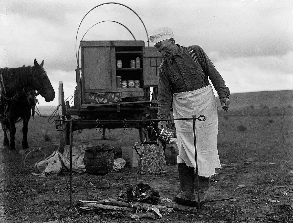 Bobby Burns puts coffee grounds in the coffee pot held over the fire by a branding iron. MS 3 Charles Belden Collection, McCracken Research Library. PN.67.97b