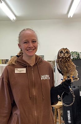 Young woman holding owl