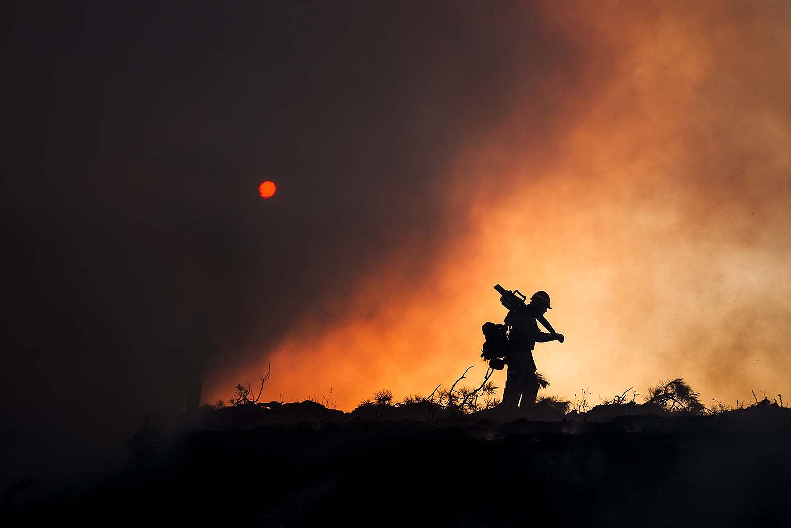 Sawyer Silhouette, from Fire on the Mountain: Photographs of Wildland Firefighting by Kyle Miller.