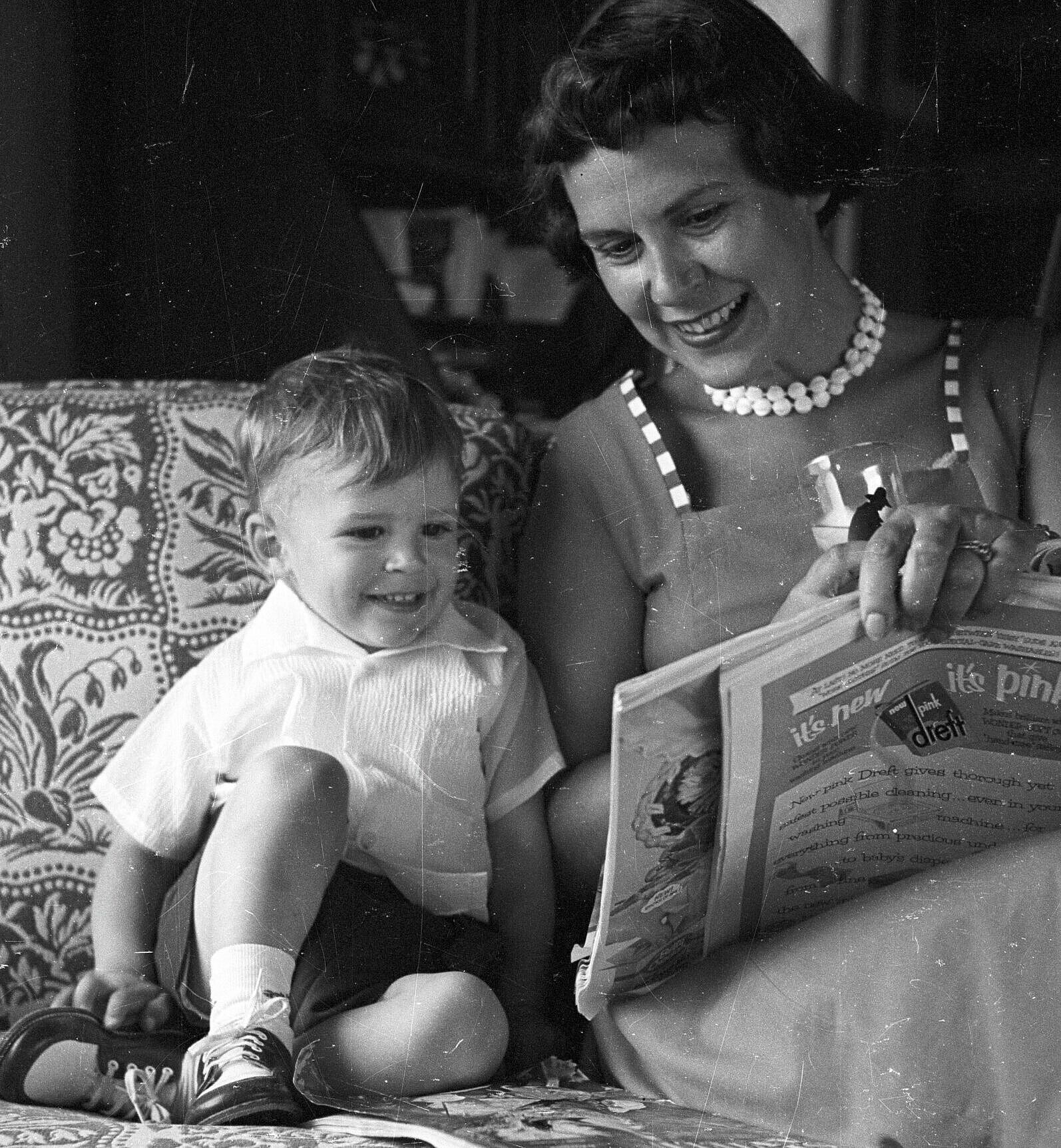 Sam Allen & family, June 26, 1955; Jerri and Sammy sitting on a couch reading a book