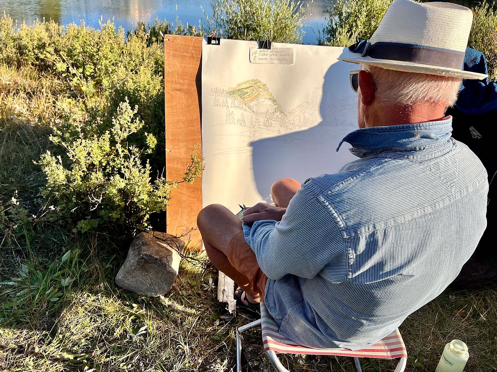 Artist Tony Foster at work, sketching the scene and colors for reference. Photograph courtesy of Karen Brooks McWhorter.
