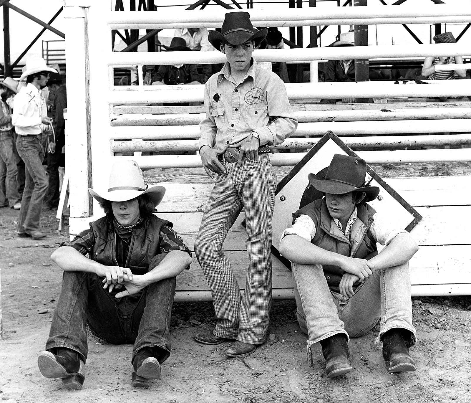 A photograph by James Bama of three young rodeo contestants taken when the Cody, Wyoming, rodeo grounds was located on Stampede Avenue, before it was moved to the West Strip on Yellowstone Avenue. MS 243 James Bama Collection, McCracken Research Library. P.243.46293