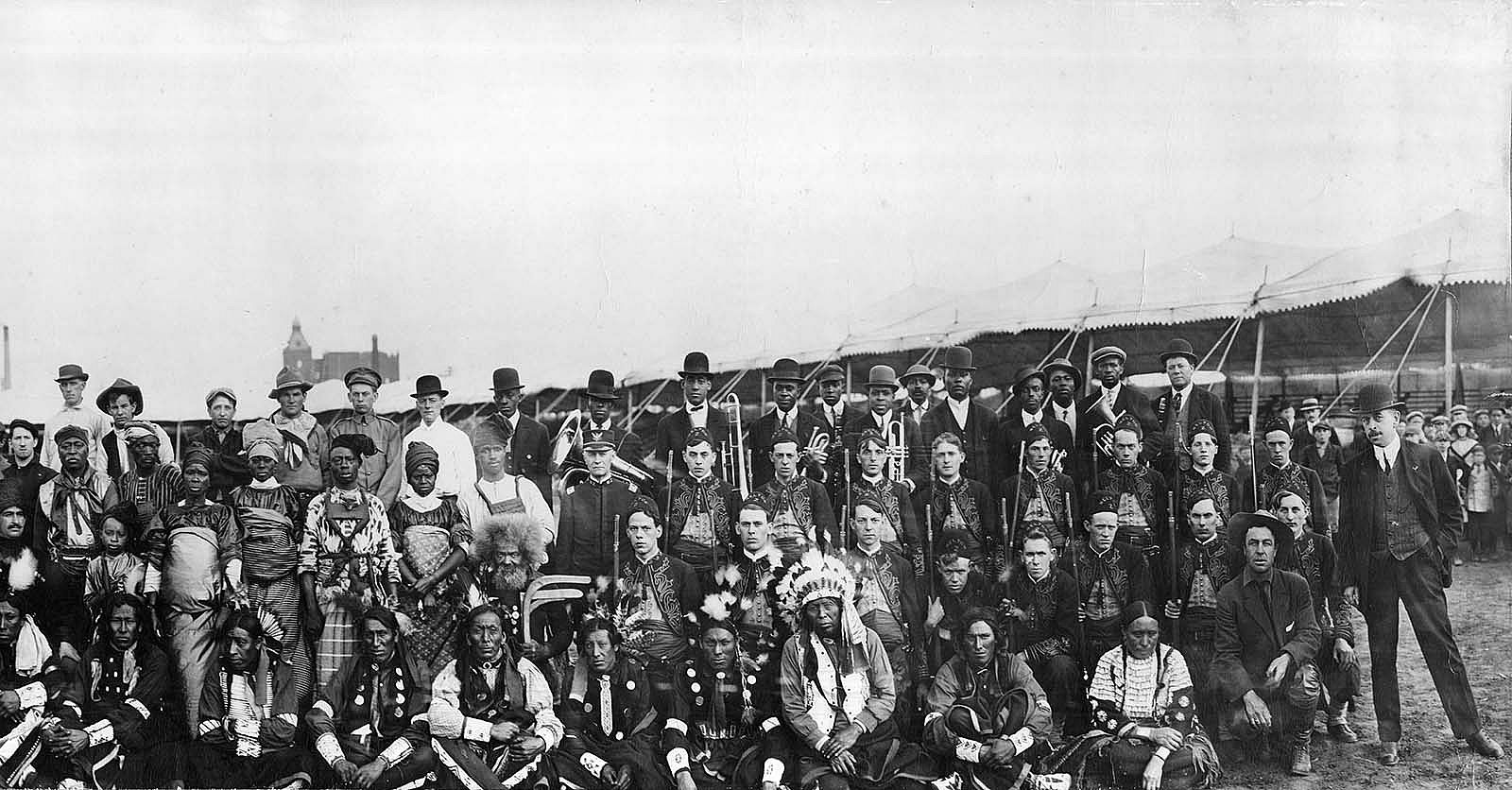 Large group of people, some with musical instruments.